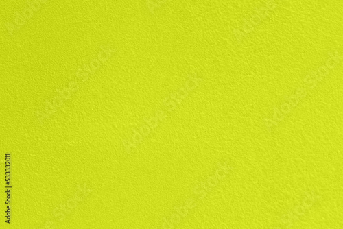 Saturated light pastel greenish yellow colored low contrast Concrete textured background. Empty colourful wall texture with copy space for text overlay and mockups. 2023, 2024 color trend