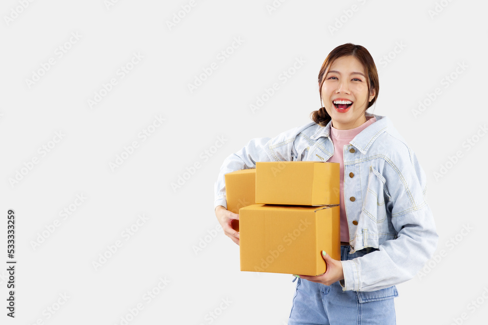 Online shopping delivery concept. Young asian girl holding and carrying brown boxes for shipping to the client. Online marketing and delivery. Online shopping delivery concept. Young asian girl holding and carrying brown boxes for shipping to the client. Online marketing and delivery.