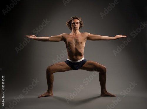 Muscular man practicing yoga in pose