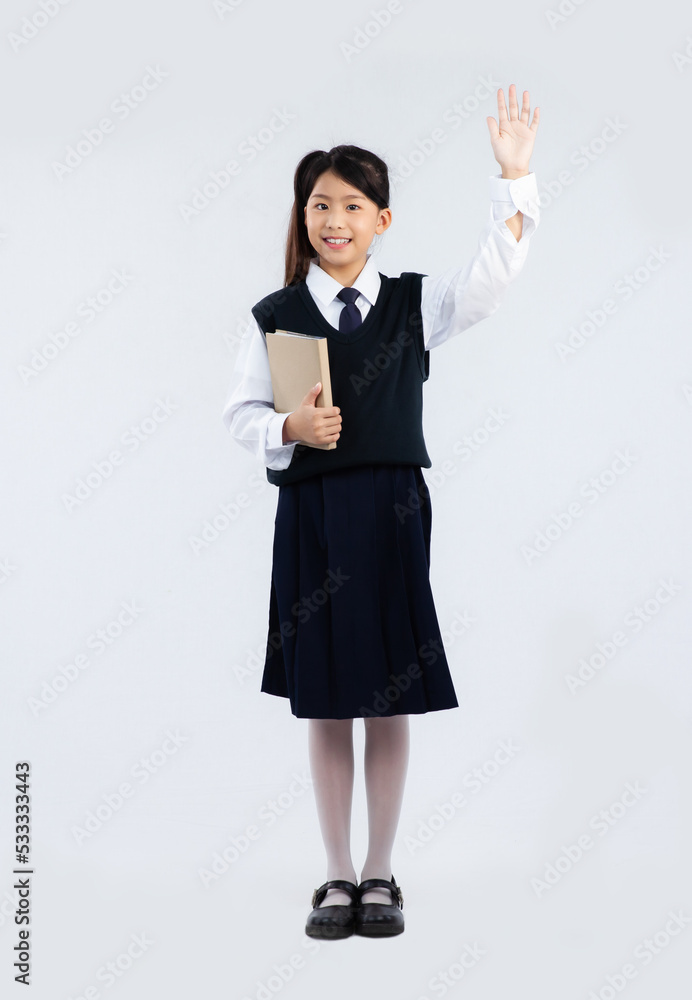 Back to school. Asian junior school student in british uniform holding a book white background. Back to school. Asian junior school student in british uniform holding a book white background.