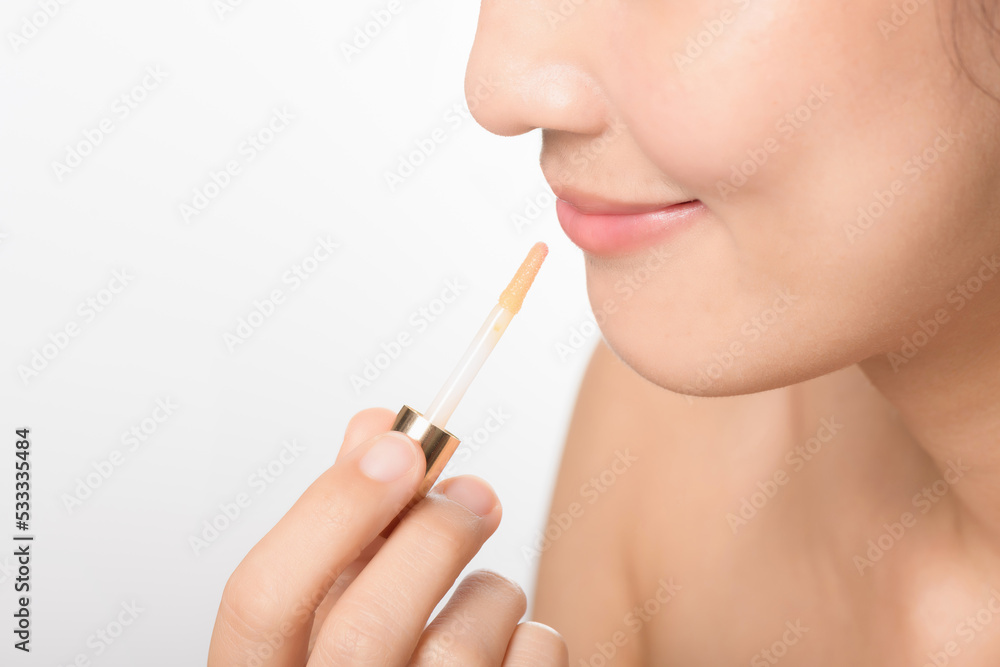Portrait young asian woman looking mirror applying makeup lipstick at room Portrait young asian woman looking mirror applying makeup lipstick at room
