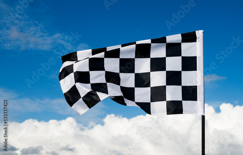 Checkered flag on blue sky