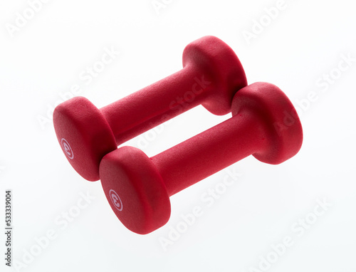 Pair of red dumbbells isolated on white