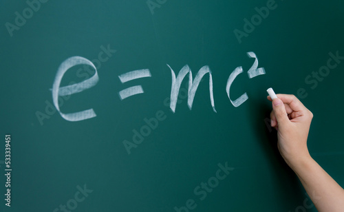 Fototapeta kuchenna Einstein equation emc2 handwritten chalk on blackboard
