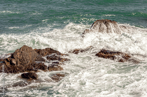 image of water falling on a rock after a wave has crashed against it.