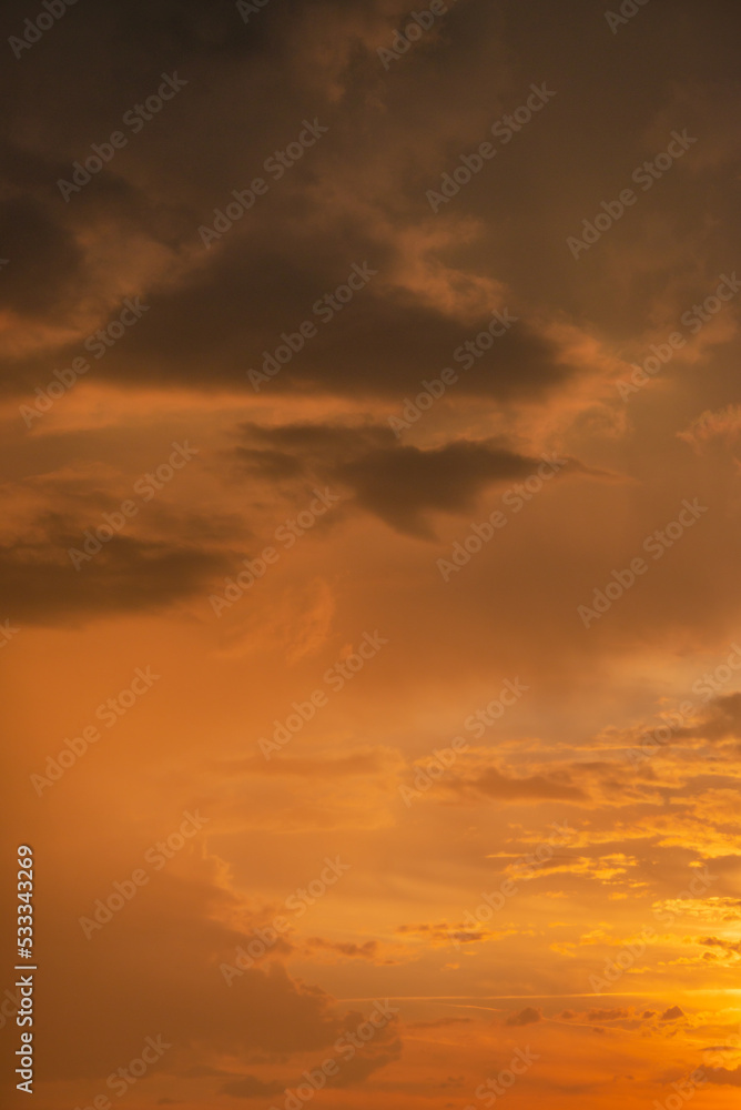 Cover page with gradient soft deep orange sky, illuminated clouds at bloody sunset as a background.