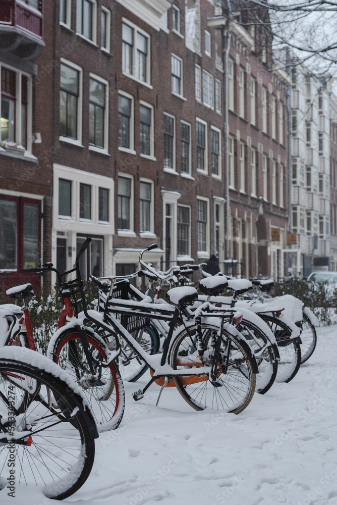 Street near the canal in the snow in Amsterdam, Netherlands.