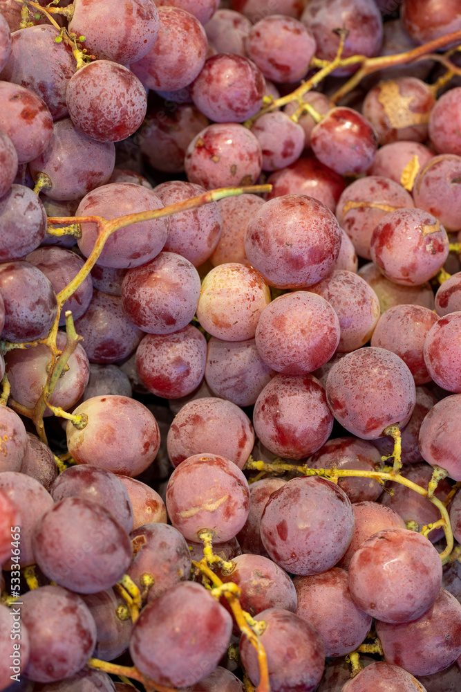 Bunch of grapes on the market counter. Pile of ripe grapes Bunch of grapes on the market counter. Pile of ripe grapes