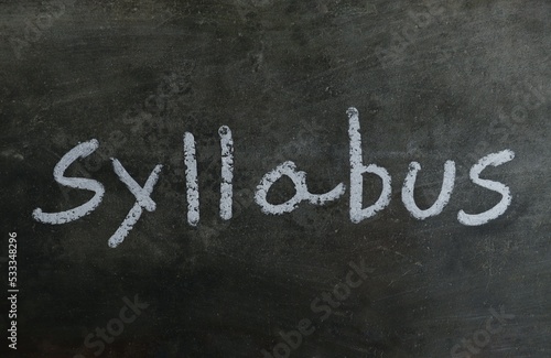Syllabus Word with Written on Blackboard with White Chalk in Horizontal Orientation photo
