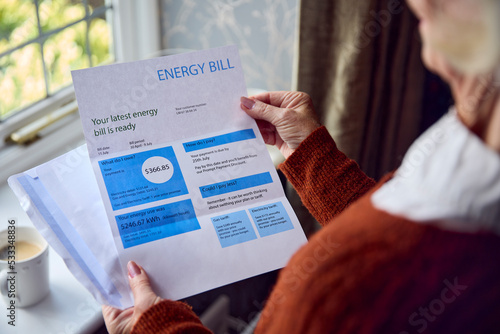 Close Up Of Senior Woman Opening UK Energy Bill Concerned About Cost Of Living Energy Crisis photo