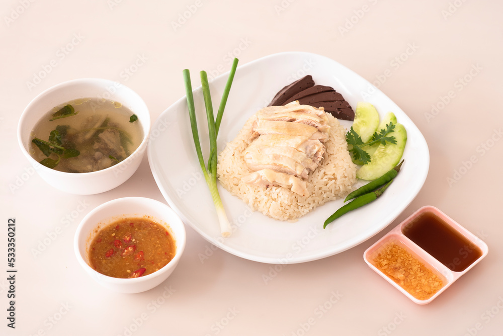 Chicken rice and dipping sauces placed nearby