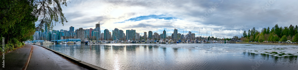 Panoramic view of Vancouver downtown from Stanley Park. Skyscrapers are reflected in the waters of Vancouver Harbor. Canada