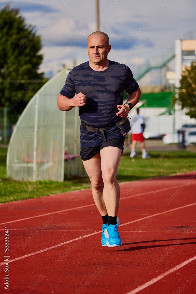 Obraz premium A man running on a running track