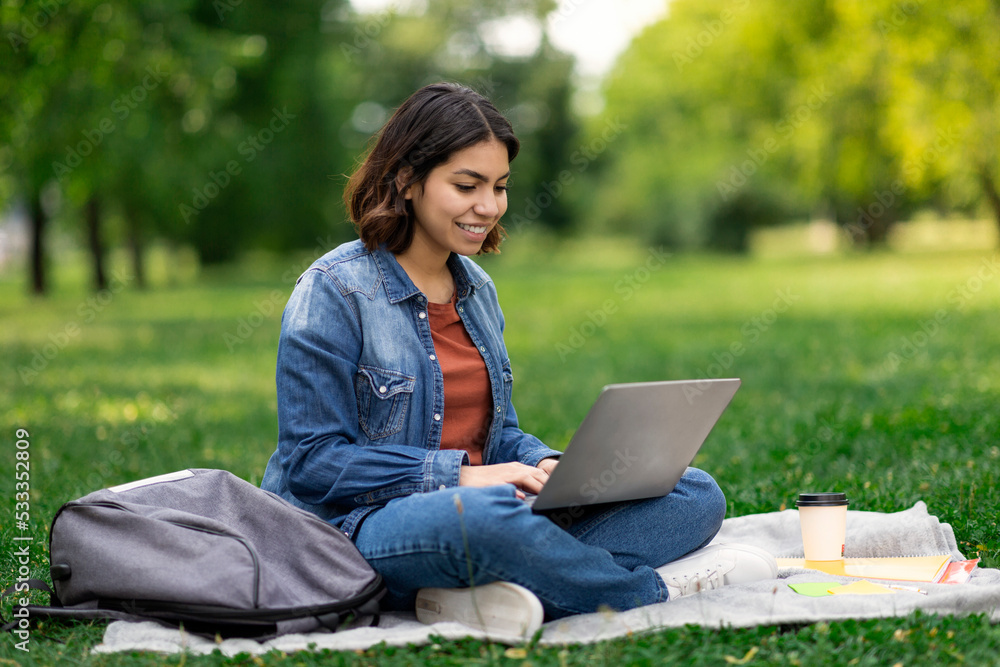 Distance Learning. Young Middle Eastern Female Student Study With Laptop Outdoors Distance Learning. Young Middle Eastern Female Student Study With Laptop Outdoors
