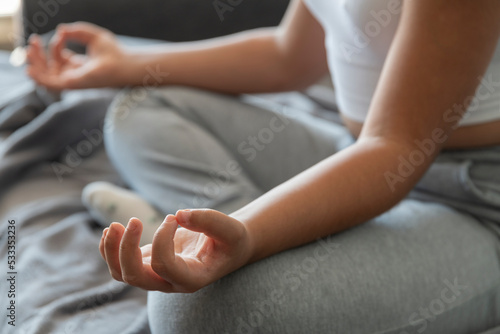 Young girl practicing yoga and meditation