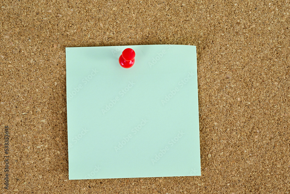 Single sticky post note on corkboard Single sticky post note on corkboard