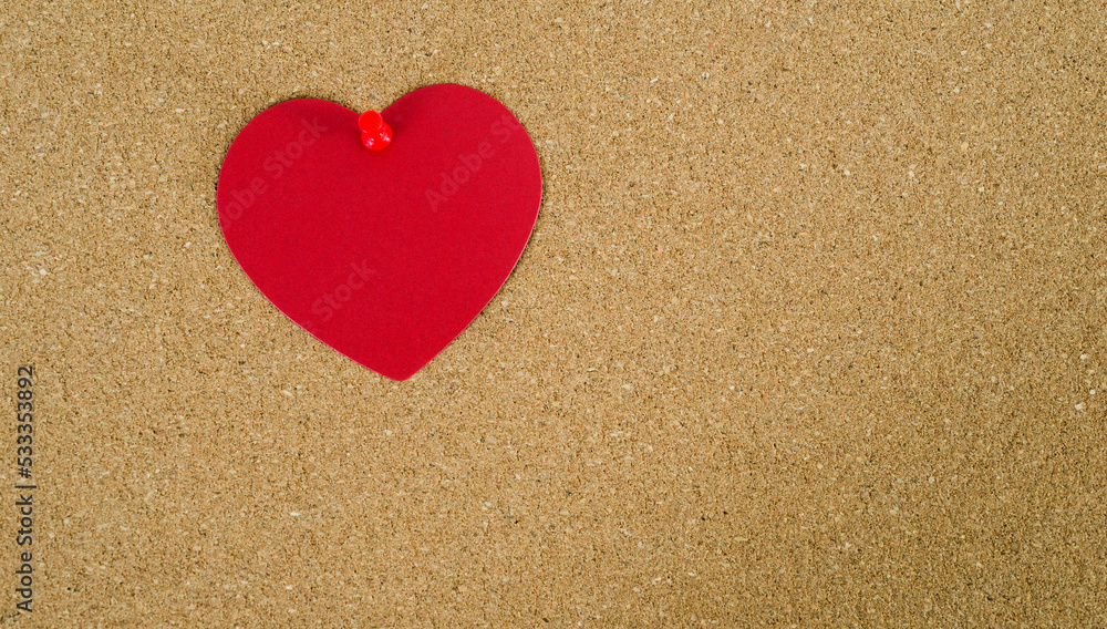 Red paper heart on cork board Red paper heart on cork board