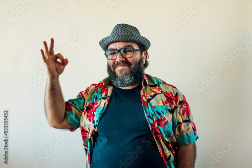 Fat man with a beard and doing the OK sign.