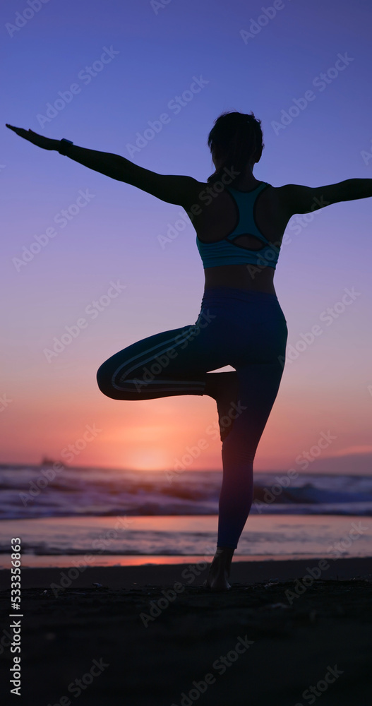 woman practice yoga on beach