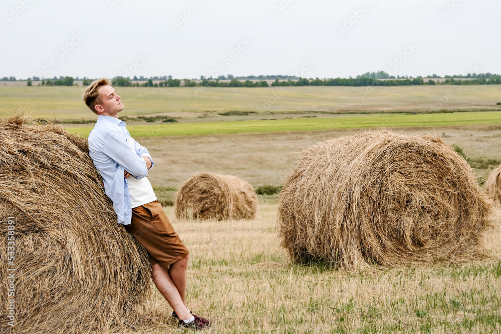 Boy Jumps From a Hay Stack in a Sunny Field