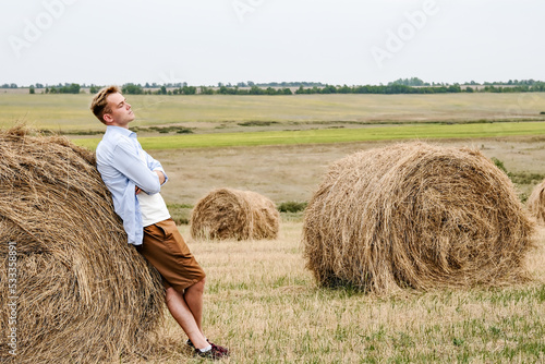 Boy Jumps From a Hay Stack in a Sunny Field © Kristina