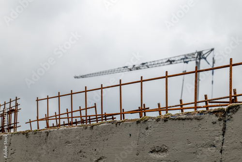 a construction site with metal rods and a crane
