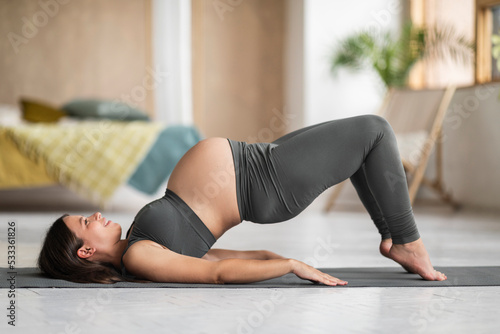 Prenatal Sport. Pregnant Young Female Training On Fitness Mat At Home