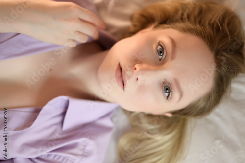 Portrait of a young woman with blue eyes. Top view.