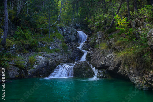 Landscape of waterfall and river in forest with moss and stones