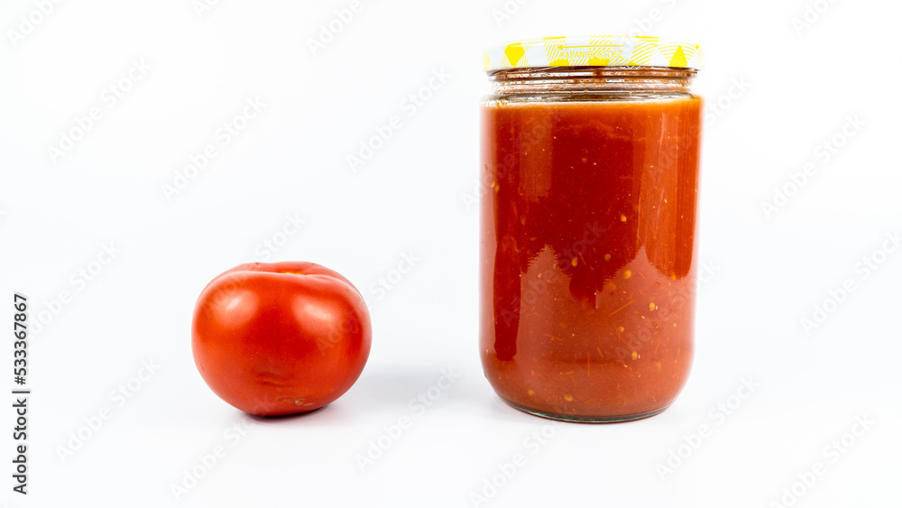 Tomato sauce in a jar. Homemade tomato sauce making process concept idea on white background. Tomato sauce in a jar. Homemade tomato sauce making process concept idea on white background.