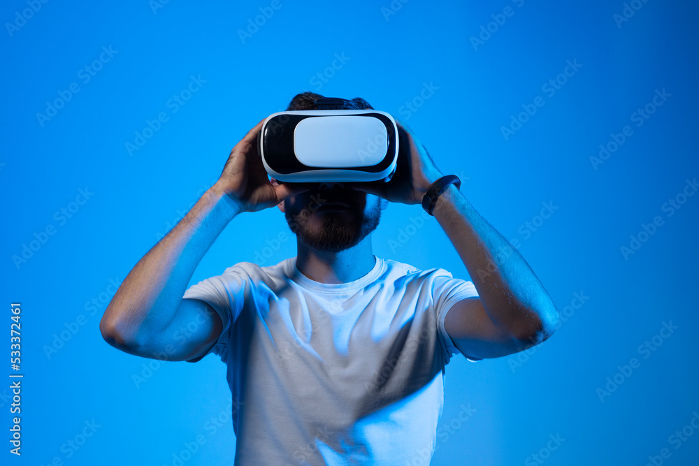 Closeup portrait of bearded man wearing VR goggles, working over virtual project, enjoying new reality, playing video game, posing isolated against violet wall. Technology, innovation gadgets. Closeup portrait of bearded man wearing VR goggles, working over virtual project, enjoying new reality, playing video game, posing isolated against violet wall. Technology, innovation gadgets.