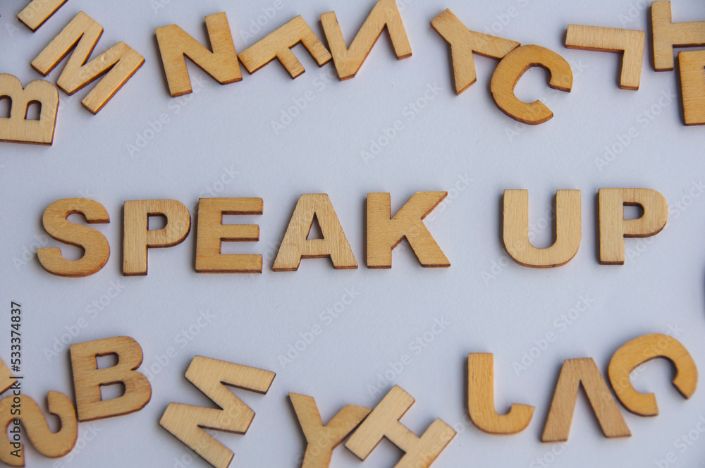 Speak up wooden text on while cover background. Courage concept Speak up wooden text on while cover background. Courage concept