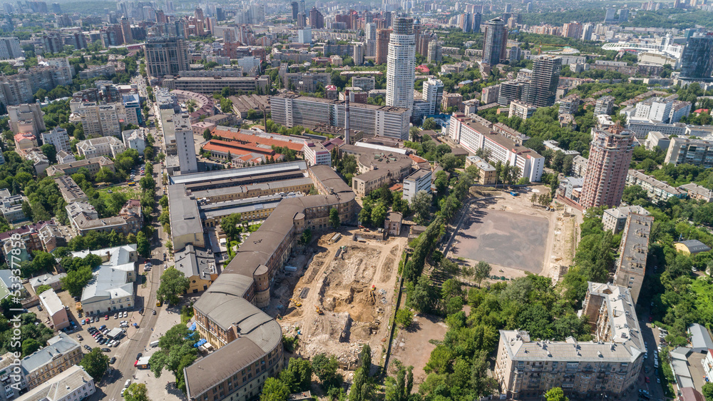 Aerial view beautiful Kyiv cityscape on a sunny summer day. Drone shot Kiev building, former factory Arsenal. Capital of Ukraine. Construction