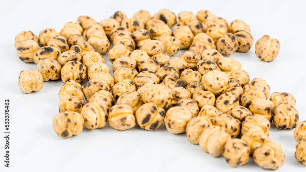 Fototapeta premium Roasted chickpea. Group of roasted chickpeas isolated on white background. selective focus. Leblebi in Turkish.