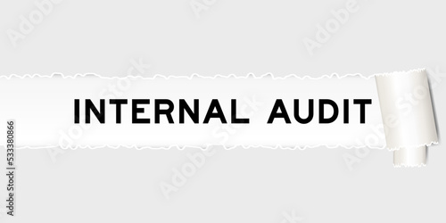 Ripped gray paper background that have word internal audit under torn part