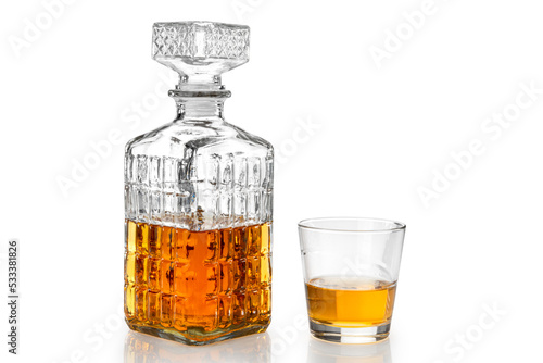 Whiskey in decorated crystal glass bottle, whisky or bourbon in vintage bottle with glass isolated on white, clipping path
