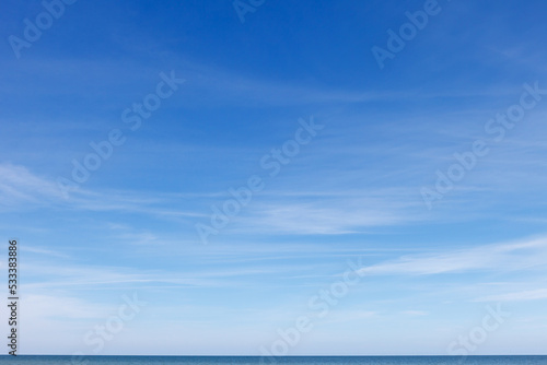 Beautiful blue sky with cirrus clouds over the sea. Skyline.
