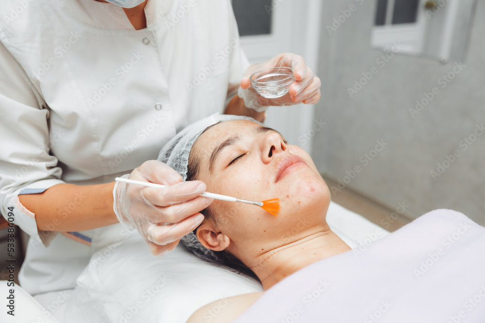 A cosmetologist does facial care and apply a face mask. cleansing a heavily soiled face. acne on the skin. skin rashes. mechanical face painting. A cosmetologist does facial care and apply a face mask. cleansing a heavily soiled face. acne on the skin. skin rashes. mechanical face painting.