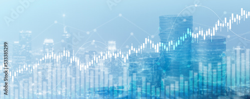 Double exposure of financial chart with line graph in stock market and stack of coins background