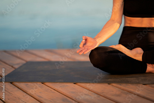 Meditation Concept. Cropped Shot Of Woman In Activewear Meditating Outdoors