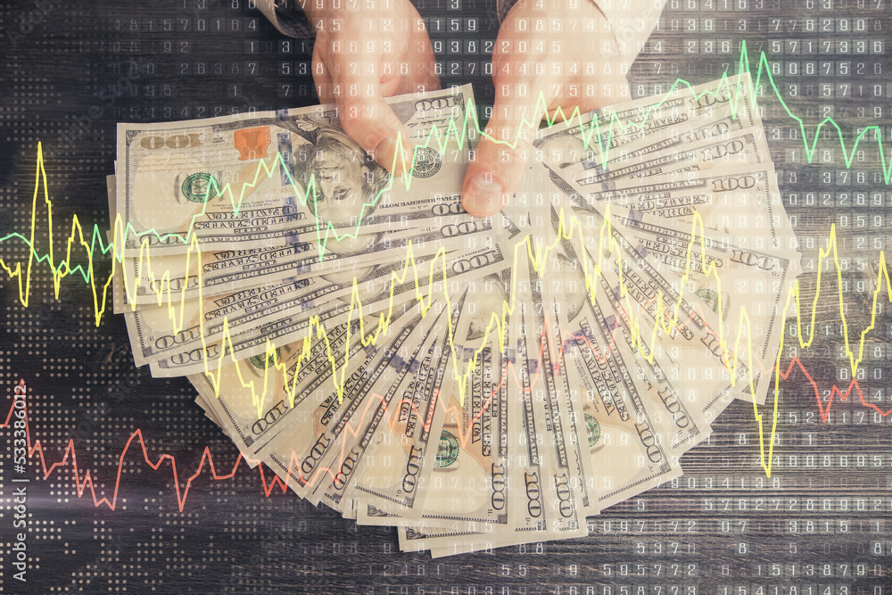 Multi exposure of financial graph drawing hologram and USA dollars bills and man hands. Analysis concept. Multi exposure of financial graph drawing hologram and USA dollars bills and man hands. Analysis concept.