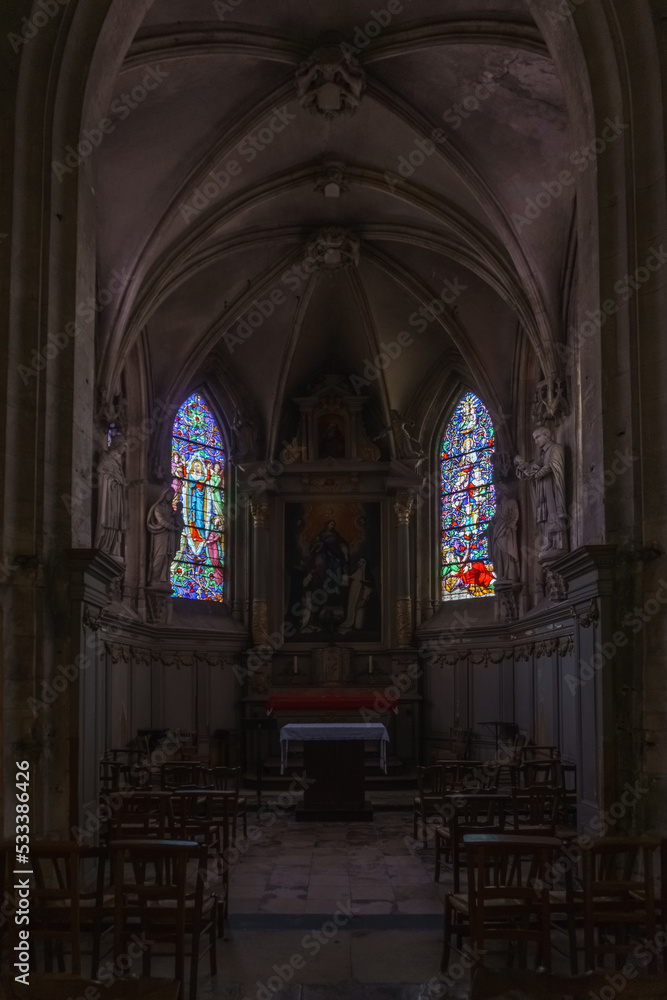 Interior of the Church of Notre-Dame with altar and colorful windows in the french town of Carentan, Normandy, France