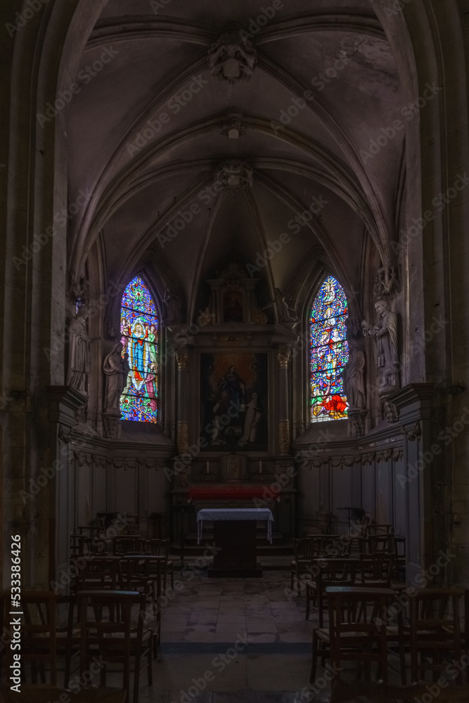 Fototapeta premium Interior of the Church of Notre-Dame with altar and colorful windows in the french town of Carentan, Normandy, France