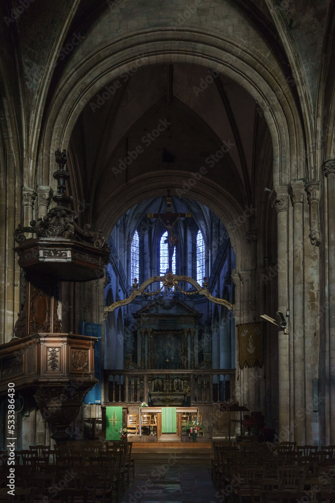 Interior of the Church of Notre-Dame with altar and colorful windows in the french town of Carentan, Normandy, France