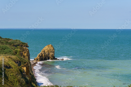 Cliffs at the northern french coast with the sea on a sunny summer day at Pointe du Hoc, Cricqueville-en-Bessin, Normandy, France