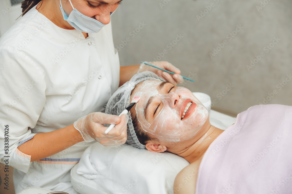 A cosmetologist does facial care and apply a face mask. cleansing a heavily soiled face. acne on the skin. skin rashes. mechanical face painting. A cosmetologist does facial care and apply a face mask. cleansing a heavily soiled face. acne on the skin. skin rashes. mechanical face painting.