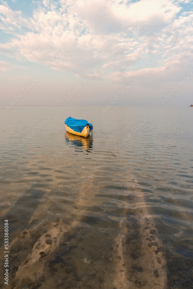 Fishers boats on the lake, calm water with beautiful reflection of colorful sky tranquily scene Fishers boats on the lake, calm water with beautiful reflection of colorful sky tranquily scene