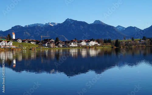 scenic and serene alpine lake Hopfensee in Schwangau with the Bavarian Alps in the background on a sunny November day (Allgaeu, Bavaria, Germany)