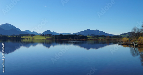 scenic and serene lake Hopfensee in Schwangau with the Bavarian Alps in the background on a sunny November day (Allgaeu, Bavaria, Germany)