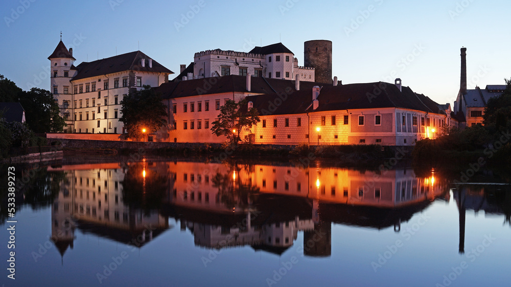 Obraz premium Jindrichuv Hradec Castle and Chateau, beautiful landmark mirroring in pond during night after sunset, popular tourist destination Jindrichuv Hradec, Czechia